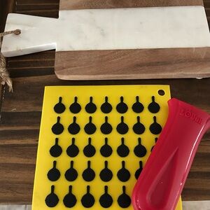Lodge Red Silicone Handle Holder and hotpad and marble and wood cutting board